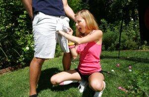 Young blonde girl Nicole Ray giving large dick oral sex outdoors on lawn on picsofsex.com