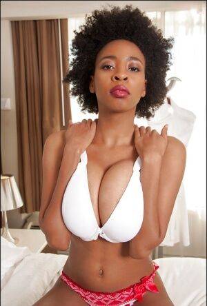 Ebony slut demonstrates her big tits in sexy glasses and red panties on picsofsex.com