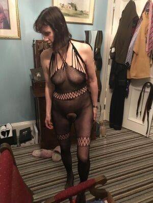 Older amateur Slut Scot Susan shows her beaver on a bed in a bodystocking - Scotland on picsofsex.com