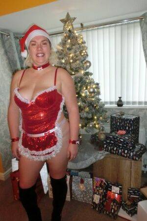 Busty blonde Barby masturbates her shaved pussy near the Christmas tree on picsofsex.com