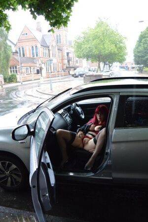 Mature redhead Barby Slut gets naked in public places on a wet day on picsofsex.com