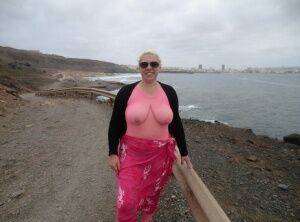 Aged lady Barby looses her big tits from a crotchless bodystocking by the sea on picsofsex.com