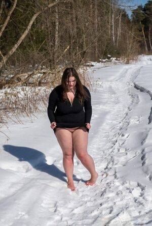 Brunette BBW rids ball gag and ropes while posing nude and barefoot in snow on picsofsex.com