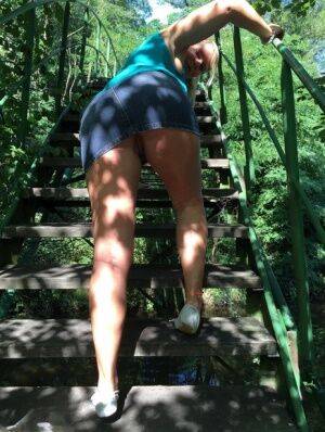 Blonde amateur Sweet Susi lifts her dress over her ass on outdoors stairs on picsofsex.com