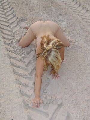 Mature blonde Sweet Susi doffs a bikini to pose naked in a sand pit on picsofsex.com