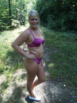 Chubby amateur MILF Sweet Susi sheds bikini bra to pose topless in the woods on picsofsex.com