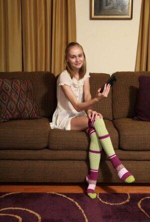 Adorable teen Alicia Williams takes a selfie before getting naked in OTK socks on picsofsex.com