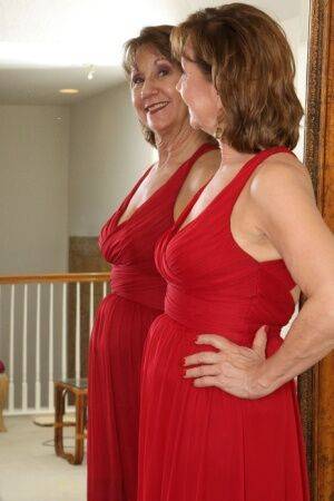 30 plus redhead Lynn doffs a long red dress before pussy play afore a mirror on picsofsex.com