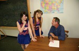 2 cheerleaders jerk off their geography teacher on top of his desk on picsofsex.com