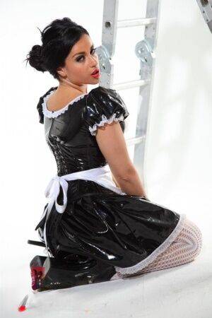 Dark-haired beauty Jasmine Jones models a latex maid uniform in sexy stockings on picsofsex.com