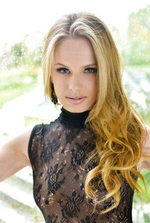 Blonde babe model Jillian Janson strutting outdoors in black bodystocking on picsofsex.com