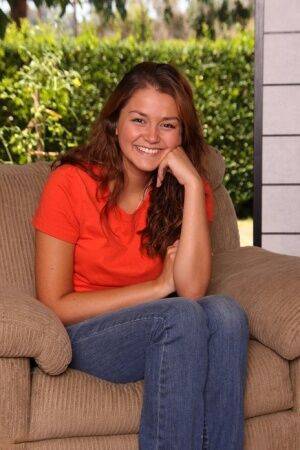 Young redhead Allie Haze sets her tan lined body free of clothes on a chair on picsofsex.com