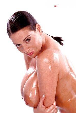 Brunette mom Linsey Dawn McKenzie oiling massive juggs, beaver and ass on picsofsex.com