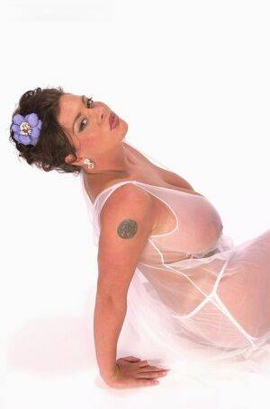 Buxom Linsey Dawn poses to flaunt her droopy tatas in sheer lingerie on picsofsex.com
