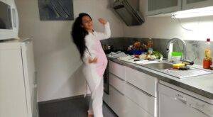 Horny and pregnant Lexi Dona undressing in the kitchen to sate her appetite on picsofsex.com