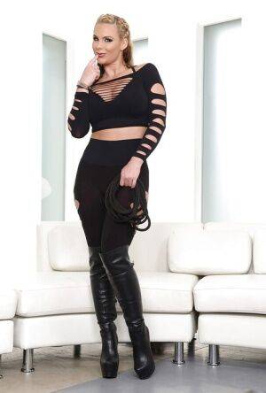 Masked blonde babe Phoenix Marie posing in over the knee black boots on picsofsex.com