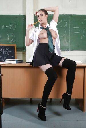 Clothed babe Connie Carter is showing off in a school uniform on picsofsex.com