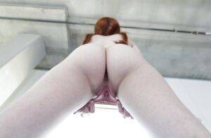 Young redhead Dolly Little revealing shaved pussy in pigtails and socks on picsofsex.com