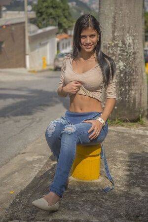 Clothed brunette teen Denisse Gomez shows off her pretty face in jean overalls on picsofsex.com