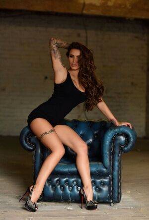 Tattooed model Gemma Massey works clear of a black dress to pose nude in heels on picsofsex.com