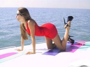 Solo girl Lori Anderson removes a red dress while getting naked atop a boat on picsofsex.com