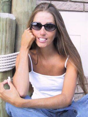 Amateur woman Lori Anderson dons sunglasses while playing with her hairy arms on picsofsex.com