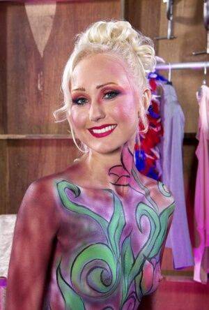 Hot older blonde Natasha Voya rocks it out wearing body paint only on picsofsex.com