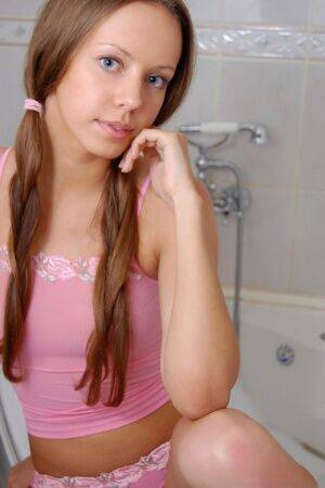 Barely legal sweetheart Natasha S sports long pigtails while taking a bath on picsofsex.com