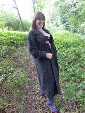 Big boobed amateur brunette in sexy lingerie Juicey Janey poses in the woods on picsofsex.com