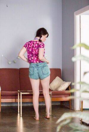 Brunette amateur Dion D pulls her panties over her bare ass while dressing on picsofsex.com