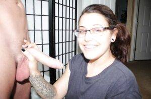 Nerdy Latina female Bella jerking big dick for mouthful of cum wearing glasses on picsofsex.com