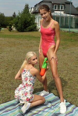 Slim teens Cindy Shine & Kiara Cole share double dildo after a water fight on picsofsex.com