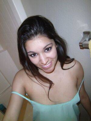 Petite amateur brunette cutie Selena takes a selfie of her hot tits and ass on picsofsex.com