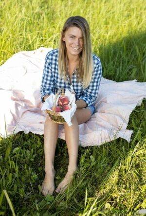 Nice teen Paulina gets completely naked on a blanket in a field on picsofsex.com