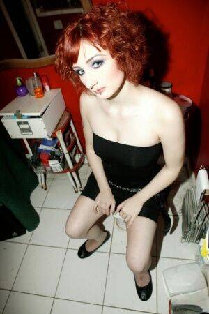 Pale redhead Violet Monroe gets naked in flat shoes while in a bathroom on picsofsex.com