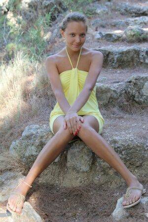 Cute teen Mango A in mini dress spreading outdoors for closeup of bald twat on picsofsex.com