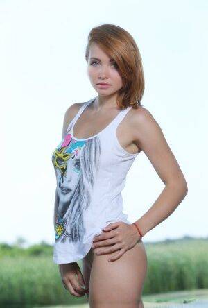 Ukrainian solo model Kika shows of her shaved pussy next to a river - Ukraine on picsofsex.com