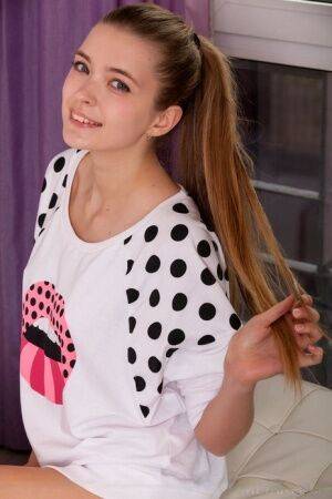 Sweet teen Sigrid shows her bald pussy with her hair in a long ponytail on picsofsex.com