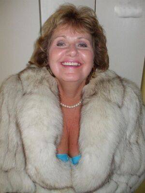 Chubby mature woman Busty Bliss releases her tan lined tits from a fur coat on picsofsex.com