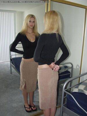 Tall blonde Brooke admires her ass in a mirror before getting naked on a bed on picsofsex.com