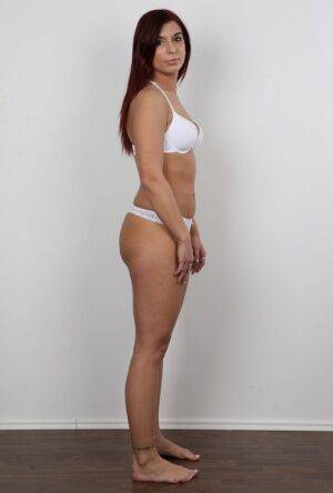 Brunette solo girl takes off all her clothes before a closeup of her bald twat on picsofsex.com