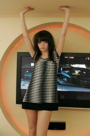 Young solo girl Kaira 18 gets totally naked in front of a television on picsofsex.com