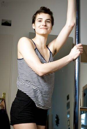 Natural hairy amateur Mayra dancing on a pole and getting naked on picsofsex.com