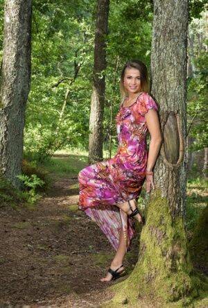 Teen model Zora A highlights her bald slit while naked in a forest on picsofsex.com