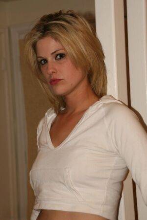 Blonde first timer Madyson showcases her bald slit on a hardwood floor on picsofsex.com