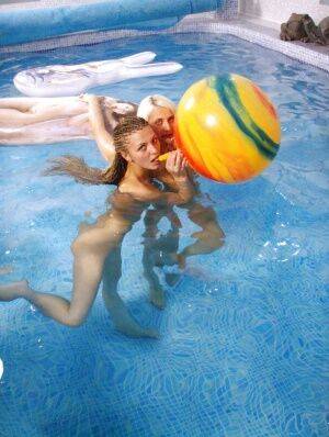 Petite teenage chicks have some lesbian fun using their toys in the pool on picsofsex.com