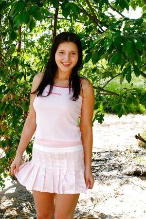 Teen ass of a brunette babe Masja C revealed outdoor in a skirt on picsofsex.com