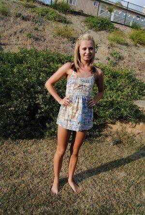 Blond amateur Tiny Tiff removes a summer dress and thong to stand nude outside on picsofsex.com