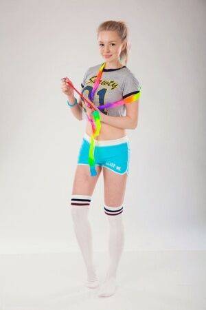 Sweet teen Lea disrobes to over the knee socks during a training session on picsofsex.com