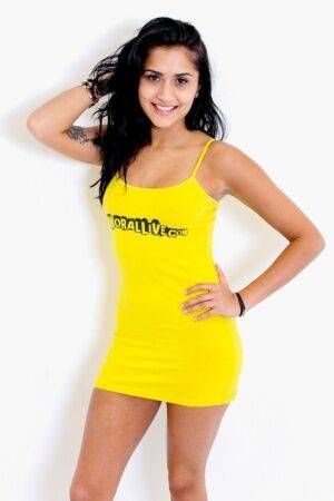 Latina teen Giselle Mari removes a yellow spaghetti strap dress to pose nude on picsofsex.com